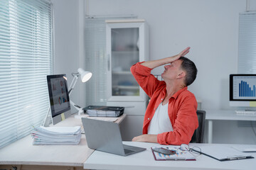 Businessman getting stressed after checking negative financial report, having problem with...