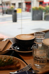 coffee cup with latte art in hand