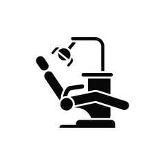 Black and white icon of a dental chair with overhead light