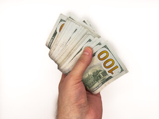 USA dollars, US money, cash, salary in dollars, dollar, mans hand is holding a stack of US dollars,...