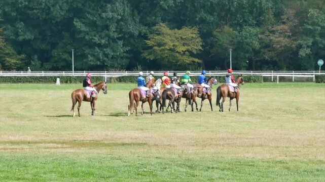 Wroclaw, Poland - September 7, 2025 Video of a group of jockeys riding horses and checking the racetrack before a horse racing competition in Wroclaw, Poland.