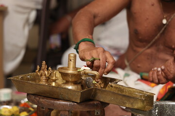 Performing Pooja for Hindu god siva linga with milk, honey and coconut water	