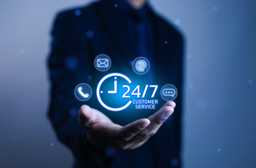 Businessman hand holding 24/7 customer service icon with digital communication technology, call center support, online helpdesk, and corporate assistance concept for global business connection.
