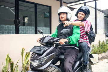 Passenger Directing The Way To Motorcycle Taxi Driver On The Street