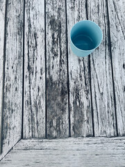 Colorful glasses in the foreground on an old rustic wooden table