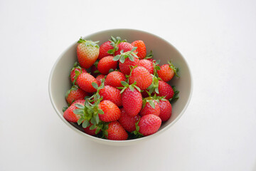 Top View of Fresh Strawberries in a Bowl on White Background