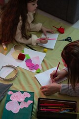 A mother and daughter spend quality time together creating handmade cards and crafts.