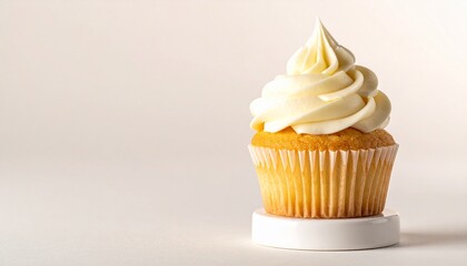 Delicious Vanilla Cupcake with Swirled Frosting on White Stand, Studio Shot