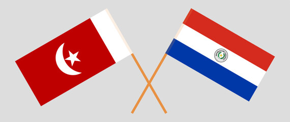 Crossed flags of The Emirate of Umm Al Quwain and Republic of Paraguay. Official colors. Correct proportion. Vector illustration