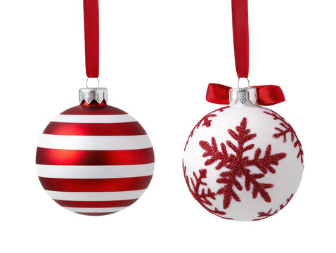 Two festive Christmas ornaments, one striped in red and white, and the other with a red snowflake design, both on red ribbons, against a white backdrop.