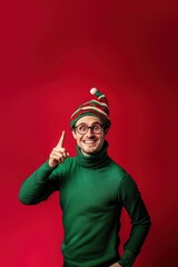 Fototapeta premium Photo of a happy man in a green turtleneck and Christmas hat on a red background sweater smiling striped.