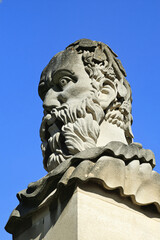 Roman emperor head in front of the Sheldonian Theatre Oxford University designed by Sir Christopher Wren between 1664-8 in Oxfordshire England UK, travel stock photo