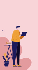 A young man, casually dressed, stands and works on his laptop in a modern, minimalist setting. Ideal for concepts of remote work, online learning, or digital lifestyle.