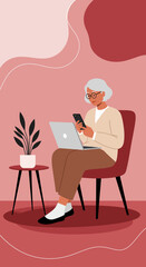 Modern senior woman comfortably uses a laptop and smartphone at home, embracing technology for communication, learning, and leisure. Represents active aging and digital literacy.