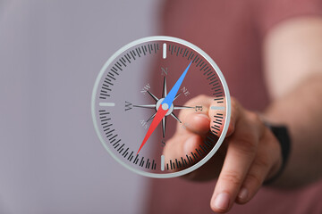 Person uses a digital compass for navigation.  Find your way with this helpful tool.