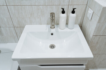This modern white bathroom sink features convenient soap dispensers, blending functionality and elegance. Its perfect for any countertop, enhancing hygiene while maintaining a minimalist look