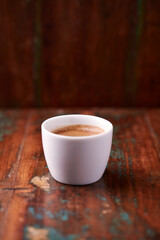 Cup of coffee on rustic wooden background. Soft focus. Copy space	