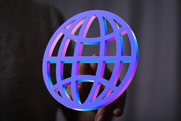Hand holding a vibrant 3D global network icon.  Represents internet, connection, technology.