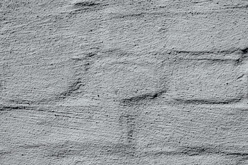 Cracked white painted brick wall for damaged building and repair concept