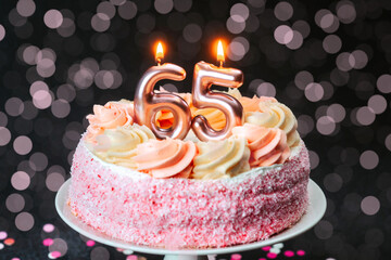 Celebrate 65th birthday with a beautifully decorated cake and candles