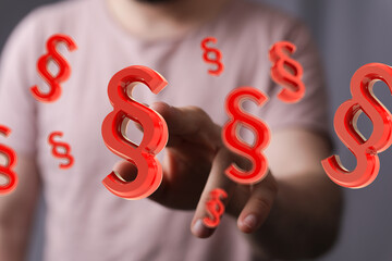 Red paragraph symbols floating around a hand.  Legal concept.
