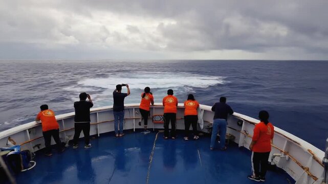 Tourists on a boat watching marine animals.