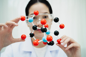 Scientist holding molecular model for chemical technology.