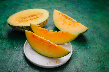 Generated image Cantaloupe melon slices on a textured green surface, fresh juicy fruit display.
