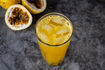 Vibrant passion fruit juice on rustic wooden background
