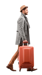 Smiling young man wearing hat and coat walking with a red suitcase.