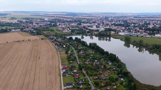 Countryside life in cottages built outside the city by a pond. Drone view of houses outside the city. Svitavy, Czech Republic