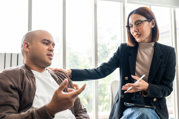 A male mental health patient consults a psychiatrist undergoing therapy and psychological...