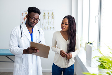 Medical Professional Explaining Health Results to a Patient in a Clinical Setting