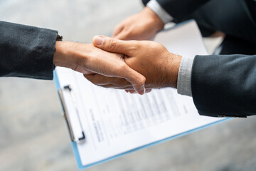A young couple discusses life health and home insurance plans with an advisor ready to sign...