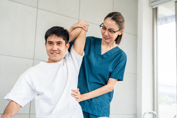 Fototapeta premium Physical therapy. Female Nurse aids young man in recovering from spine injury and providing orthopedic massage Orthopedic healthcare and chiropractor with person for physical therapy rehabilitation
