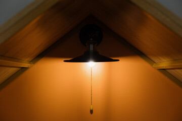 Warm light illuminating the cozy wooden interior of a rustic room