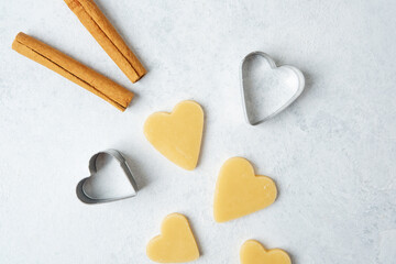 Heart cookie dough and cutter with cinnamon for valentine food photography or romantic concept