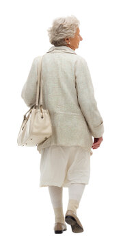 Senior woman walking away carrying a white handbag with elegant outfit