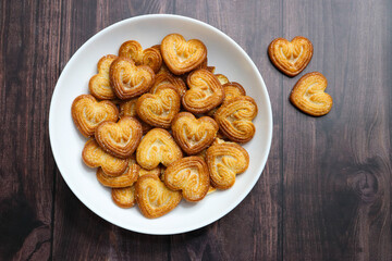 Golden, heart shaped crispy biscuits with a light, flaky texture, coated with sparkling sugar...