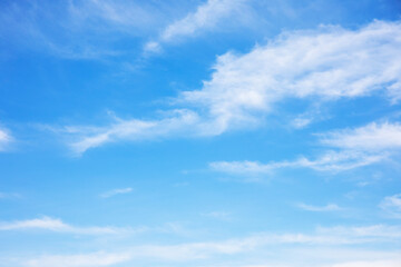 Blue sky background and white clouds soft focus, and copy space horizontal shape.