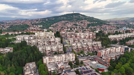 Aerial Drone View of Housing Development in Sarajevo, Bosnia and Herzegovina — Expanding City with Distant Mountain with Communication Tower - 29.97fps and UHD - Powered by Adobe