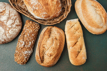 Freshly baked artisan breads arranged in a natural setting on a table