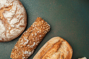 Freshly baked bread rolls on a rustic countertop display at a bakery
