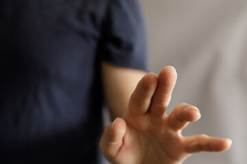 Obraz premium Close-up of a hand making a stop gesture. Perfect for concepts like rejection, denial, or boundaries. High-quality image for websites and presentations.
