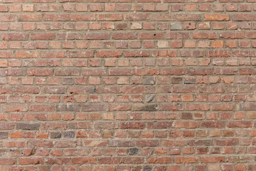 Fototapeta premium High-resolution photo of a rustic red brick wall, perfect for backgrounds, textures, and design projects. Download now!