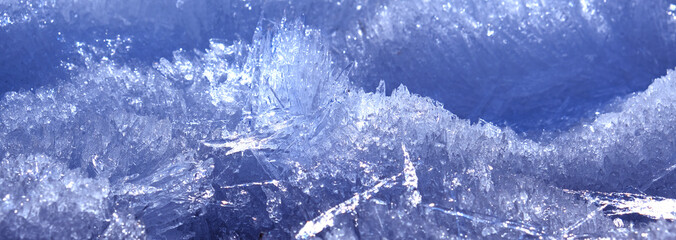Arctic ice. Monochrome frozen background with light and shadow. A scattering of large long ice...