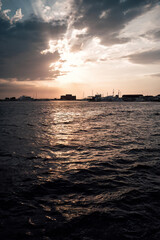 Naklejka premium Paphos Castle emerging from the sea at sunset with dramatic sky in Cyprus