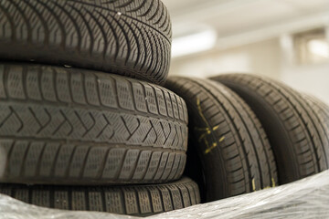 Obraz premium High-quality photo of a stack of used car tires. Perfect for automotive, recycling, or industrial themes. Download now!