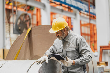 Senior staff worker in heavy industry, healthy elderly supervisor man work in metal sheet factory