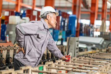 Senior Asian worker muscle pain, Suffer from back pain, health problem at work